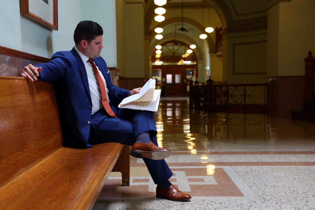 Norris Legal Group founder Graham Norris studies documents in a courthouse.