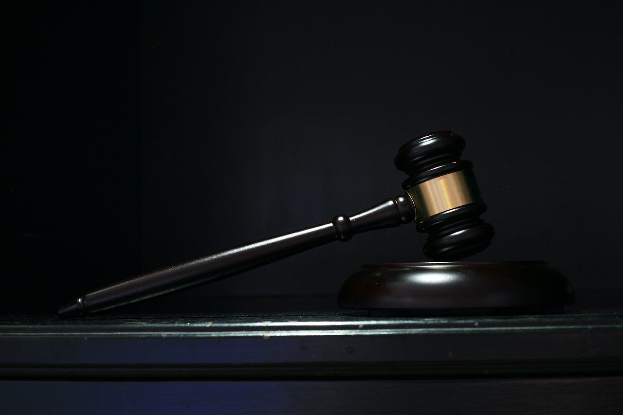 A gavel in front of a dark background.