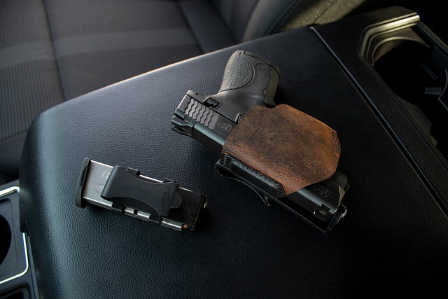 A pistol and a clip sitting on top of a vehicle's center console.