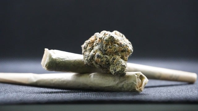 A close-up of two marijuana joints and a clump of marijuana bud.