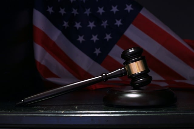 A gavel with an American flag in the background.