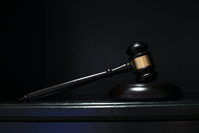 A dark gavel on a black background.